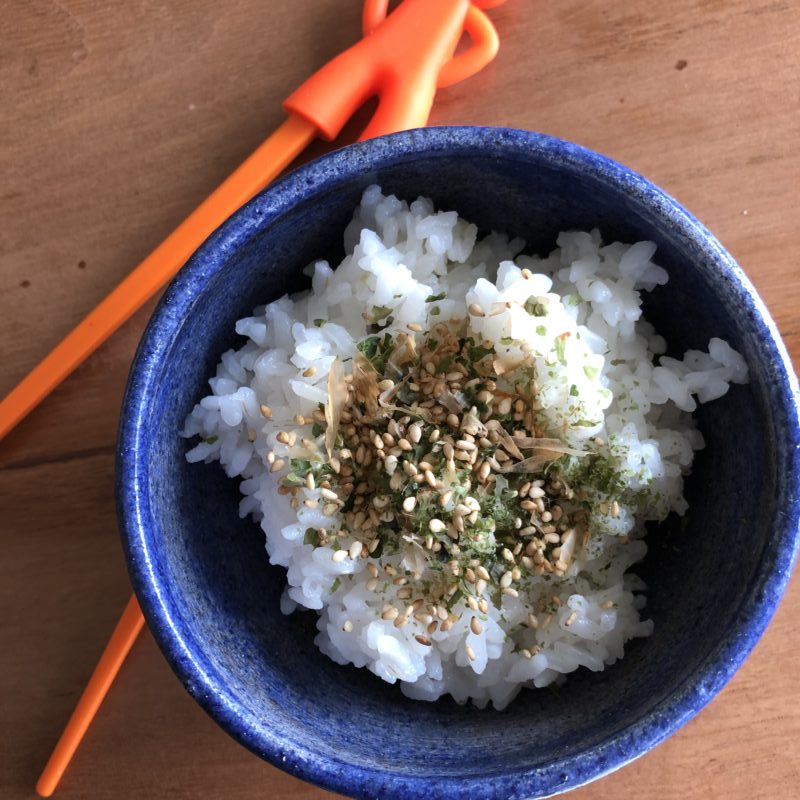 top view of a bowl of sushi rice with furikake to illustrate the recipe